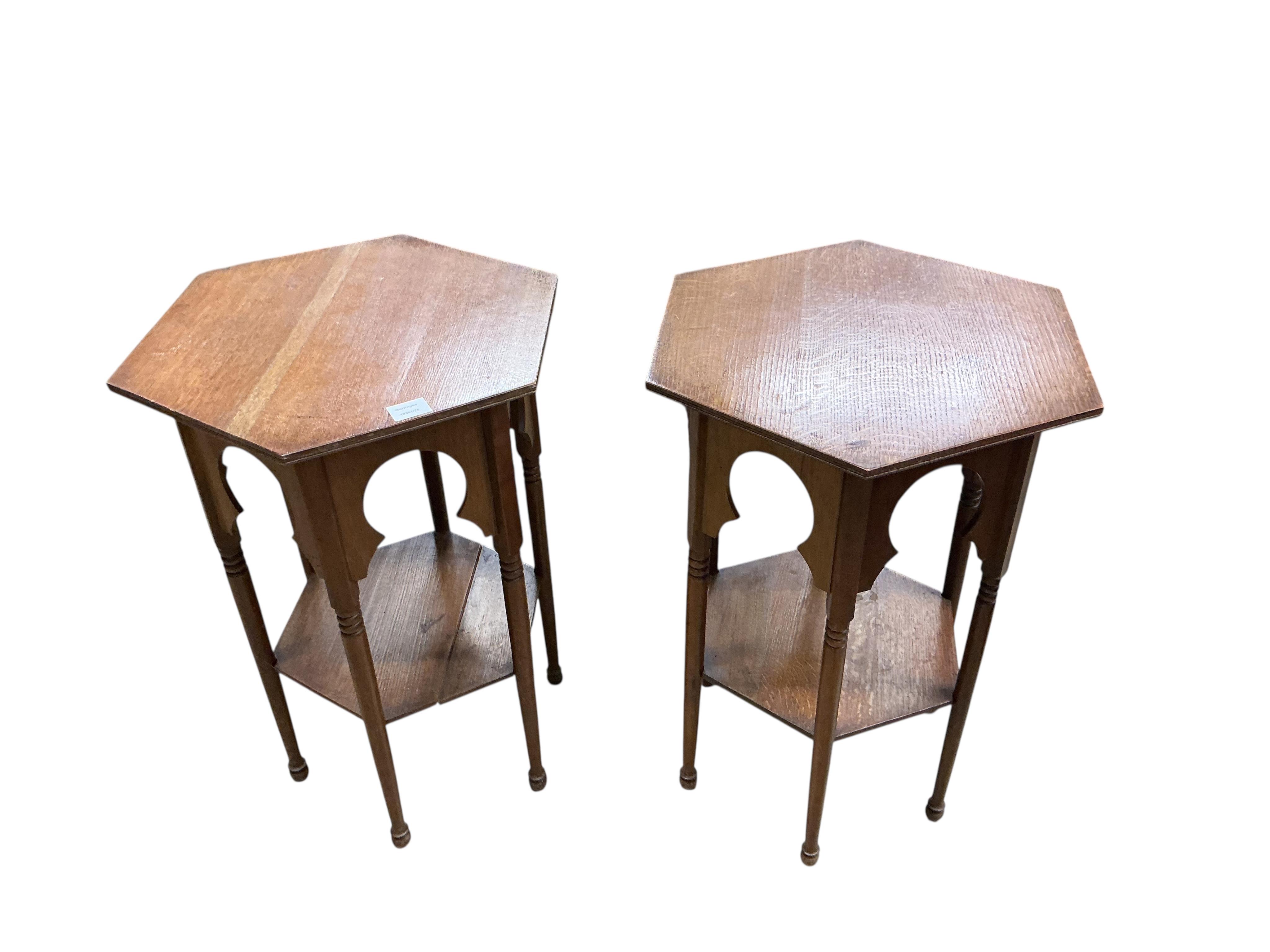 A pair of early 20th century Liberty style hexagonal oak two tier occasional tables, width 48cm, height 71cm
